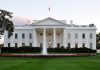 The White House with fountain and American flag.