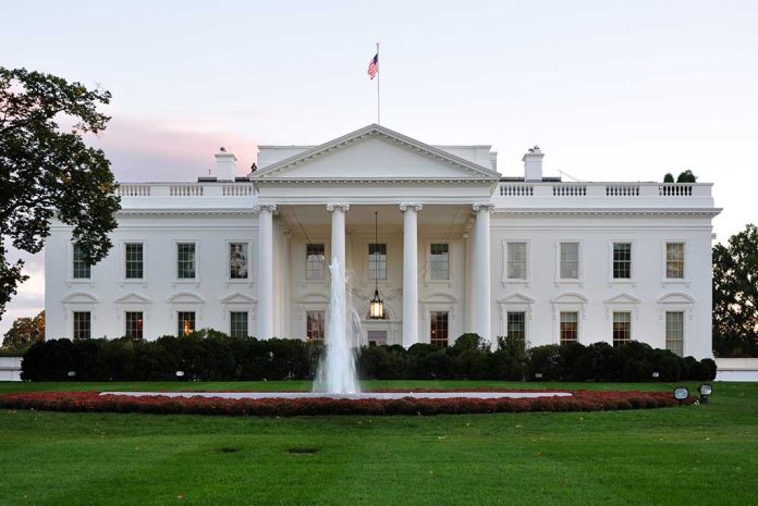 The White House with fountain and American flag.