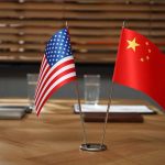 American and Chinese flags on a conference table.