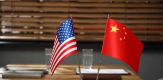 American and Chinese flags on a conference table.