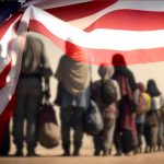 Line of people walking under American flag overlay.