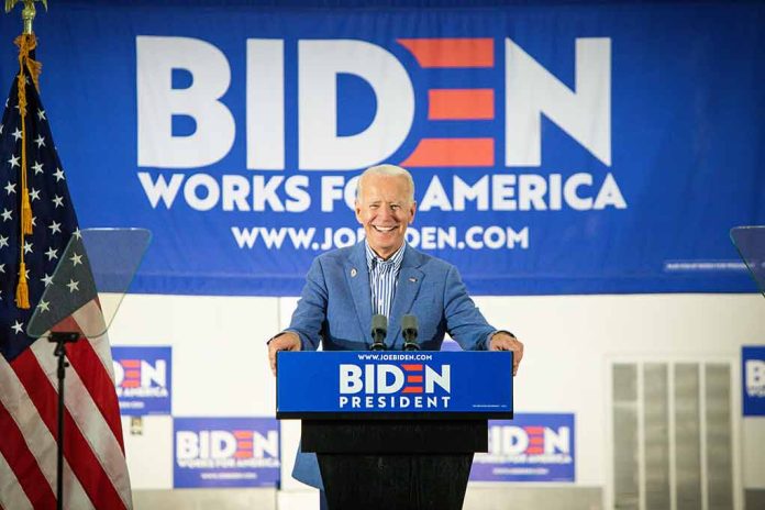 Man at podium with Biden campaign signs behind him.