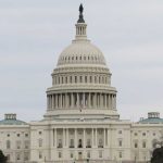 United States Capitol building under cloudy sky.