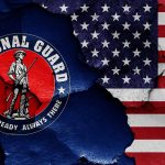 "National Guard logo and American flag with cracks."