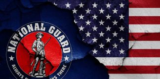 "National Guard logo and American flag with cracks."