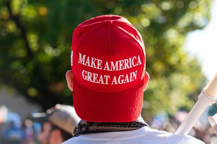 Red "Make America Great Again" hat on person's head.