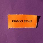 "Product Recall" text on orange paper, purple background.