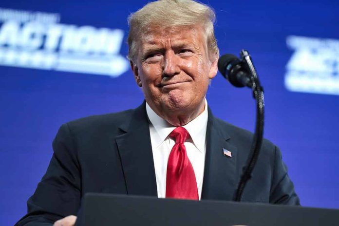 Man in suit and red tie at podium.