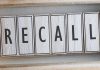 The word "RECALL" on wooden tiles.