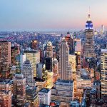 New York City skyline at dusk with skyscrapers.