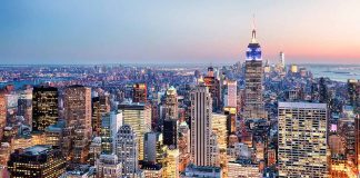 New York City skyline at dusk with skyscrapers.