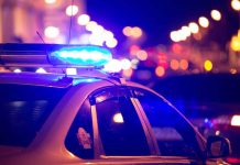 Police car with blue lights at night.