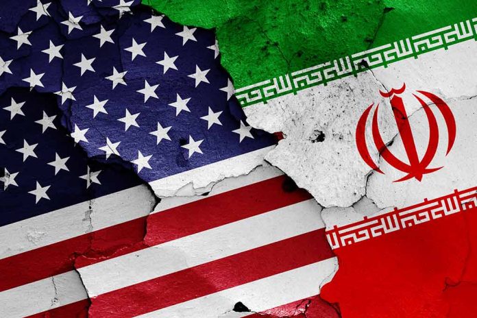 Cracked American and Iranian flags on a wall.