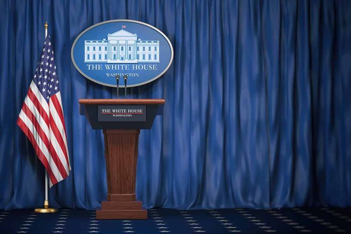 Empty White House podium and American flag.