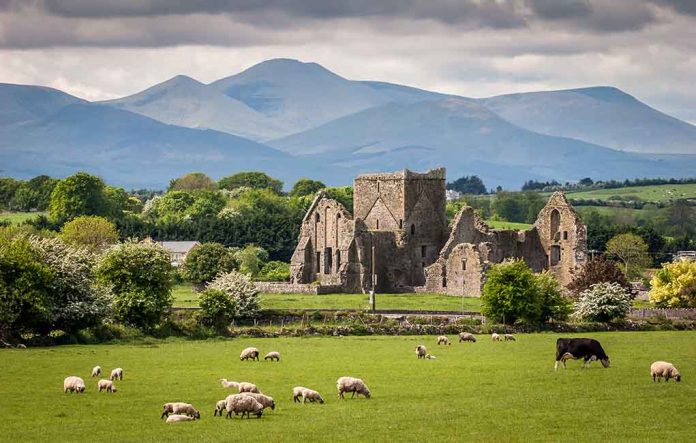 Ruins, sheep grazing, mountains and cloudy sky.