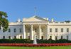 White House with fountain and flowers in foreground.