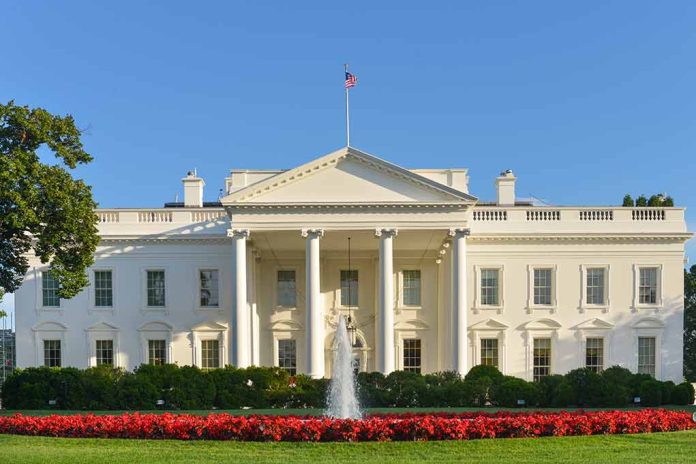 White House with fountain and flowers in foreground.