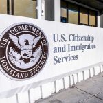 U.S. Citizenship and Immigration Services building sign.