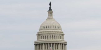 United States Capitol building under cloudy sky.