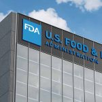 FDA building with blue logo and sky background.