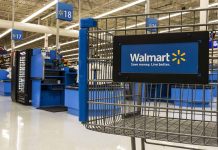 Walmart shopping cart inside store near checkout aisle