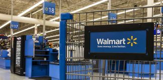 Walmart shopping cart inside store near checkout aisle