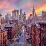 City skyline at sunset over busy urban street