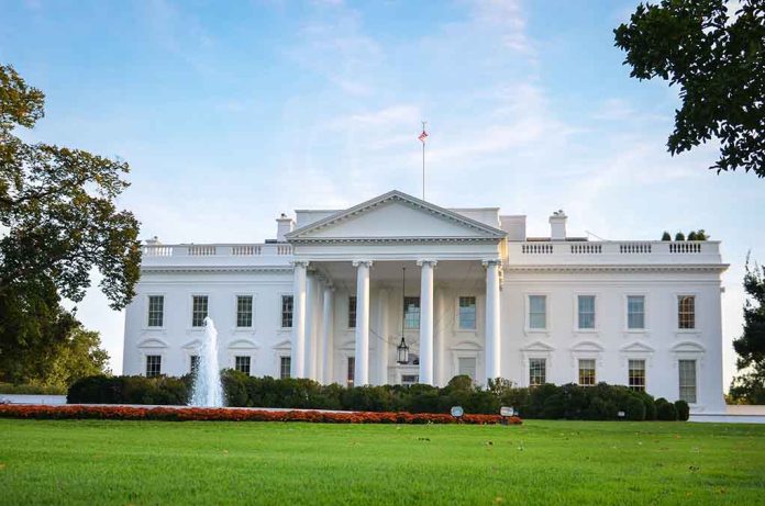 White house with fountain and flags, front view.