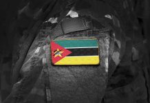 Mozambican flag patch on camouflage uniform sleeve.