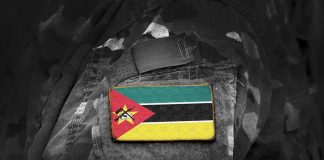 Mozambican flag patch on camouflage uniform sleeve.