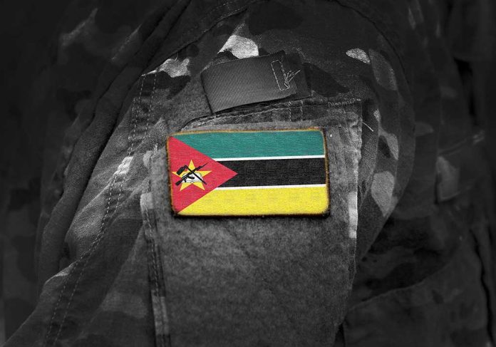 Mozambican flag patch on camouflage uniform sleeve.