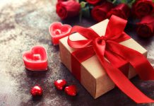 Gift box with red ribbon and heart candles