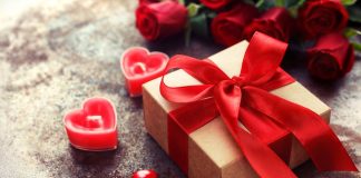 Gift box with red ribbon and heart candles