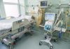 Hospital bed in ICU with monitoring equipment.