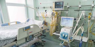 Hospital bed in ICU with monitoring equipment.