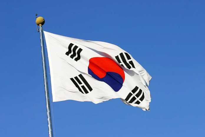 South Korean flag waving against clear blue sky.