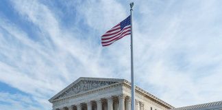 Supreme Court building with American flag flying.