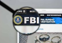 Magnifying glass over FBI logo on webpage