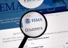 Magnifying glass over FEMA Disasters webpage.