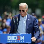 Man speaking at outdoor campaign event with sunglasses