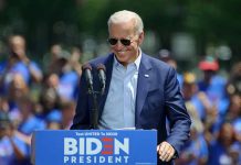 Man speaking at outdoor campaign event with sunglasses