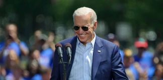 Man speaking at outdoor campaign event with sunglasses