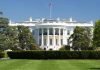 White House with American flag and green lawn