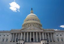 U.S. Capitol building against a clear blue sky.