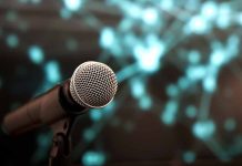 Microphone with abstract, blurred blue background.