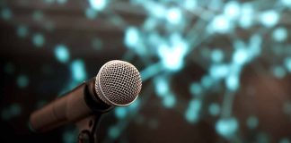 Microphone with abstract, blurred blue background.