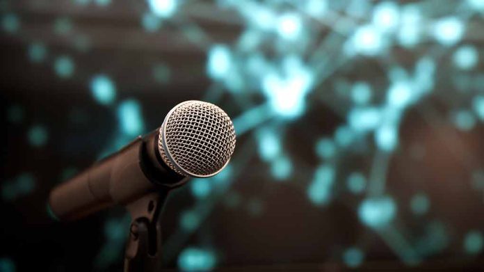 Microphone with abstract, blurred blue background.