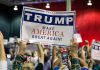 Sign at crowded rally for Trump campaign.