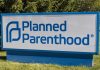 Planned Parenthood sign on a grassy lawn.