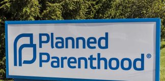 Planned Parenthood sign on a grassy lawn.